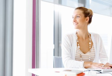 Çekici ofis çalışanı masada oturuyor.