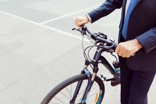 Successful businessman riding bicycle — Stock Photo, Image