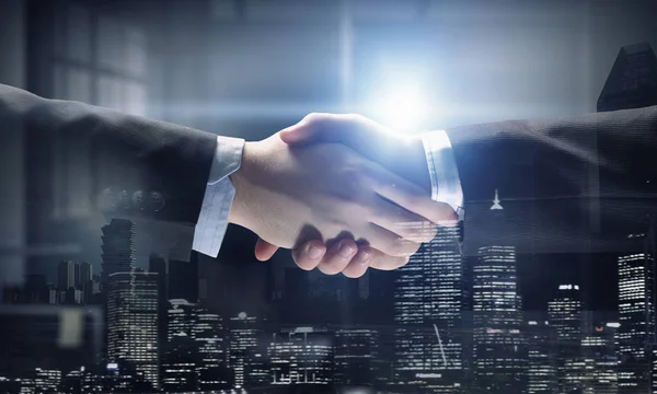 Partners shaking hands as symbol of deal — Stock Photo, Image