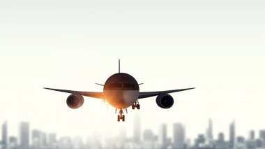 Cityscape üzerinde yolcu uçağı