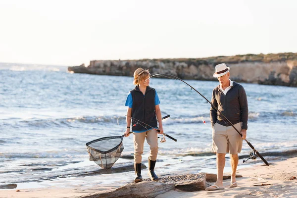 Senior man fishing with his grandson — Stock Photo, Image