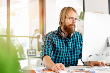 Genç adam ofiste çalışıyor.