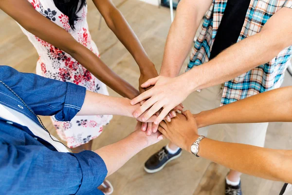 Top view of young people putting hands together — Stock Photo, Image