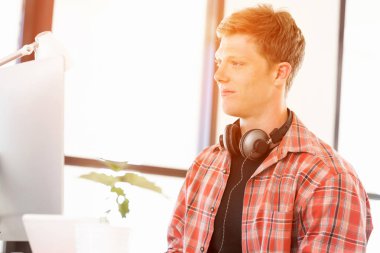 Genç adam ofiste çalışıyor.