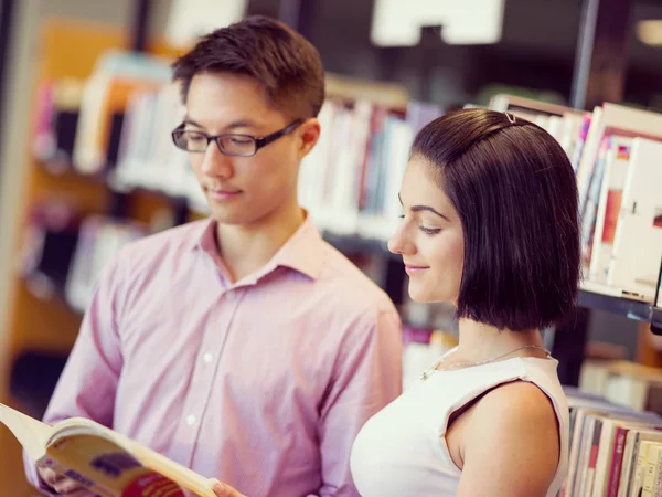 Groep van jonge studenten in de bibliotheek — Stockfoto