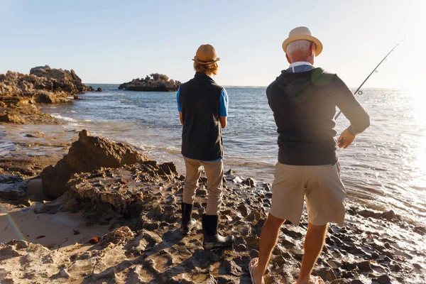 Senior man fishing with his grandson — Stock Photo, Image