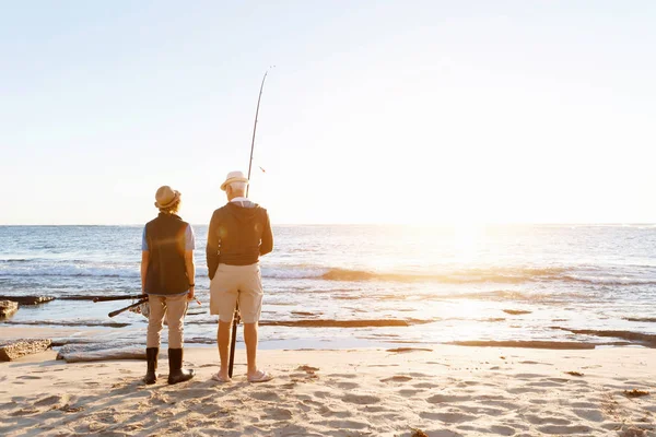 Senior man fishing with his grandson — Stock Photo, Image