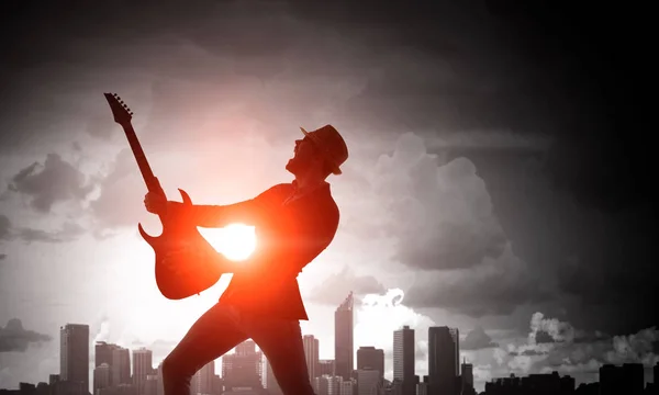 Rock kille med gitarr. Mixed media — Stockfoto