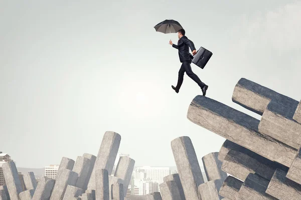 Elegant banker with umbrella. Mixed media — Stock Photo, Image