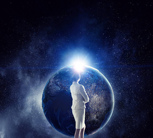 Businesswoman and Earth planet. Elements of this image are furnished by NASA. Mixed media