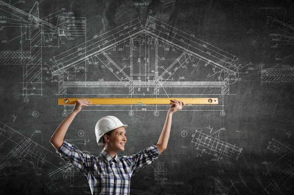 Builder woman taking measures . Mixed media — Stock Photo, Image