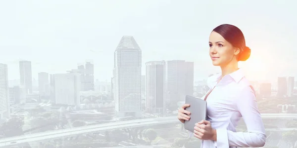 Businesswoman and modern city background. Mixed media — Stock Photo, Image