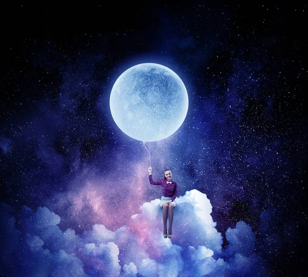 Woman sitting on cloud . Mixed media — Stock Photo, Image