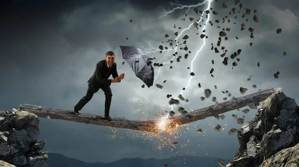 Businessman with black umbrella. Mixed media — Stock Photo, Image