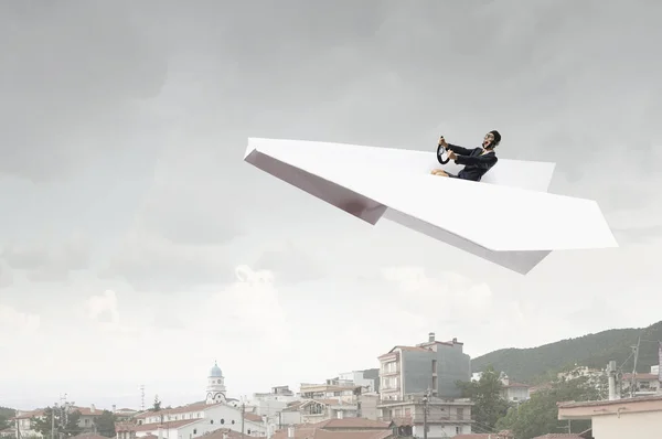 Woman pilot in paper plane. Mixed media — Stock Photo, Image