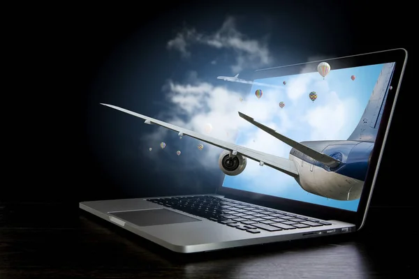 Airliner coming from laptop. Mixed media . Mixed media — Stock Photo, Image