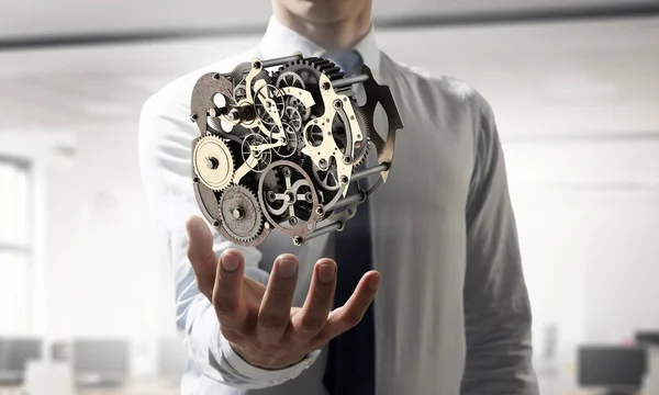 Kugghjulet mekanism i hand. Mixed media. Mixed media — Stockfoto