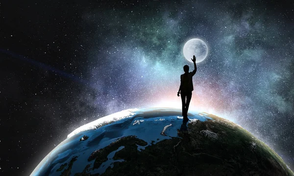 Young woman reaching moon — Stock Photo, Image