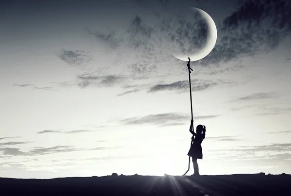 Kid girl catching moon — Stock Photo, Image
