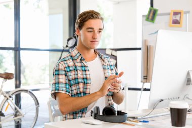 Genç adam ofiste çalışıyor.