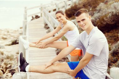 Kaçakçıları. Egzersiz ve stertching sahilde genç Çift