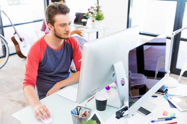 Genç adam ofiste çalışıyor.