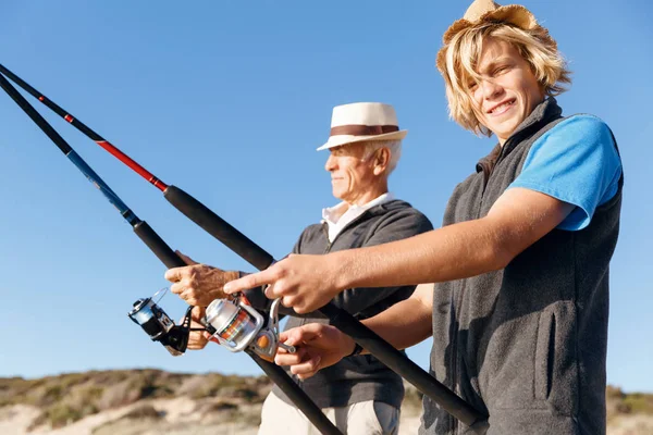 Hombre mayor pescando con su nieto —  Fotos de Stock