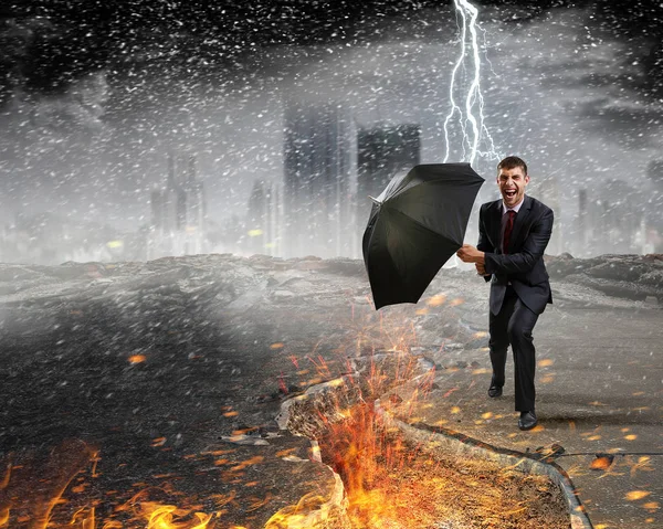 Businessman with black umbrella. Mixed media — Stock Photo, Image