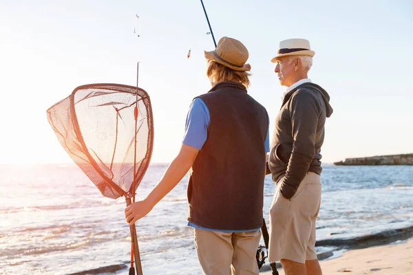 Yaşlı adam torunuyla balık tutuyor.
