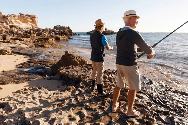 Yaşlı adam torunuyla balık tutuyor.