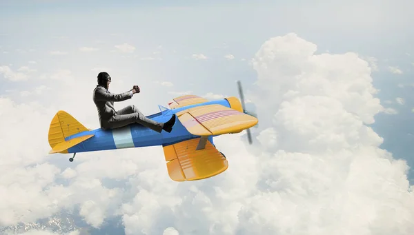 Man flying in retro plane. Mixed media — Stock Photo, Image