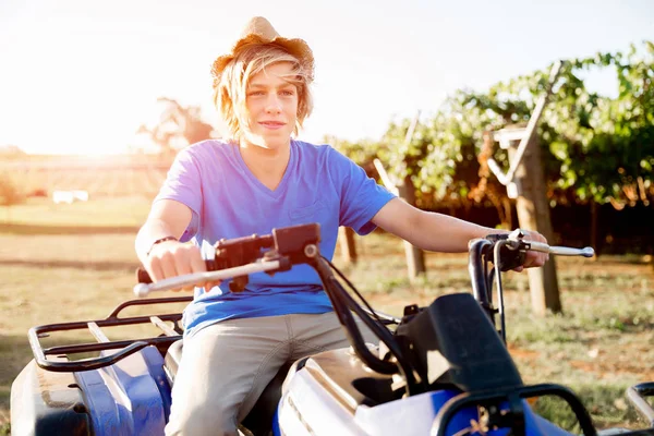 Boy riding farm truck in vineyard — Stock Photo, Image