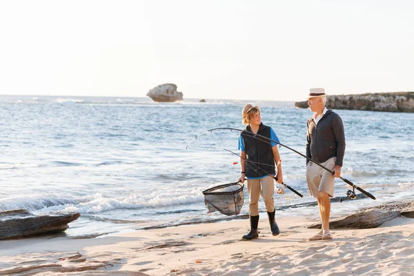 Senior man fishing with his grandson — Stock Photo, Image