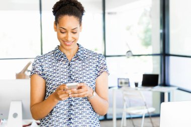 Afro-Amerikan ofis çalışanı ile cep telefonu iş içinde gülümseyen portresi
