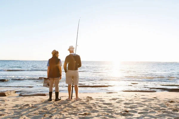 Senior man fishing with his grandson — Stock Photo, Image