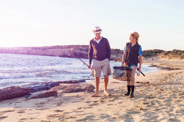 Senior man fishing with his grandson — Stock Photo, Image