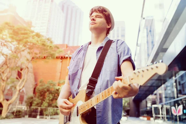 Young musician with guitar in city — Stock Photo, Image