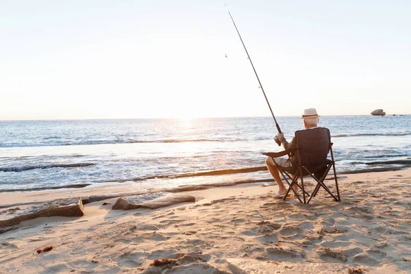 Hombre mayor pescando en el lado del mar —  Fotos de Stock