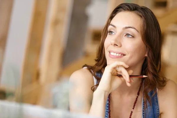 Mujer bonita joven sentada en su escritorio — Foto de Stock