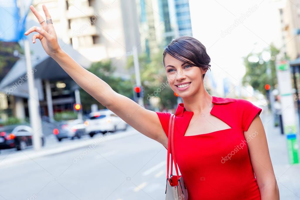 Businesswoman trying to catch a taxi