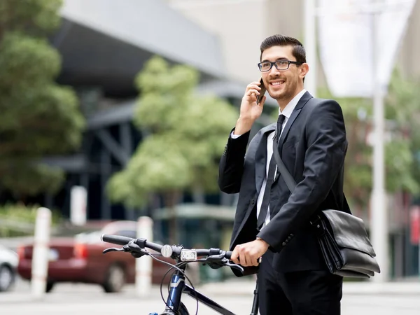 Young businessmen with a bike — Stock Photo, Image