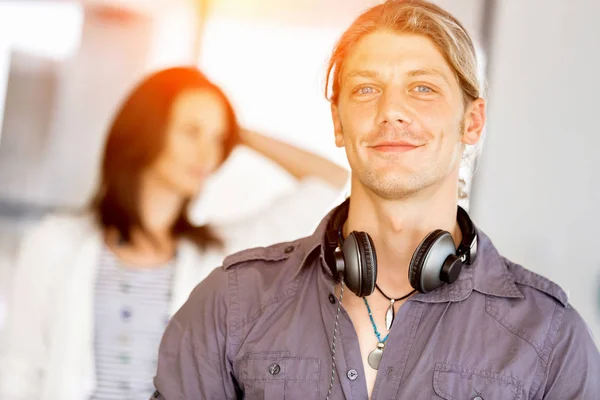 Young caucasian businessman standing in office — Stock Photo, Image