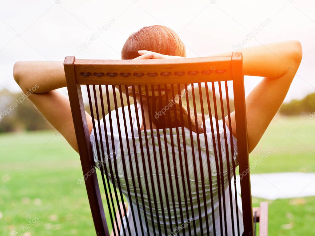 Young businesswoman relaxing during her break in park