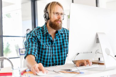 Genç adam ofiste çalışıyor.