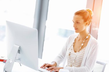 Çekici ofis çalışanı masada oturuyor.