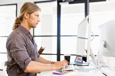 Bilgisayarda çalışan yakışıklı işadamı