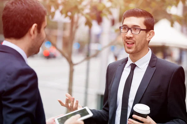 Two businessmen talking outdoors — Stock Photo, Image