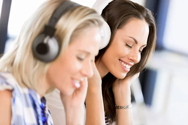 Young woman with headphones indoors — Stock Photo, Image