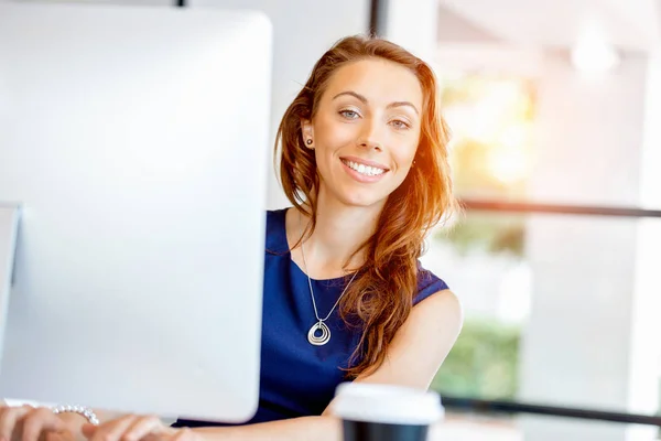 Portrait of businesswoman working at her desk in office — Stock Photo, Image