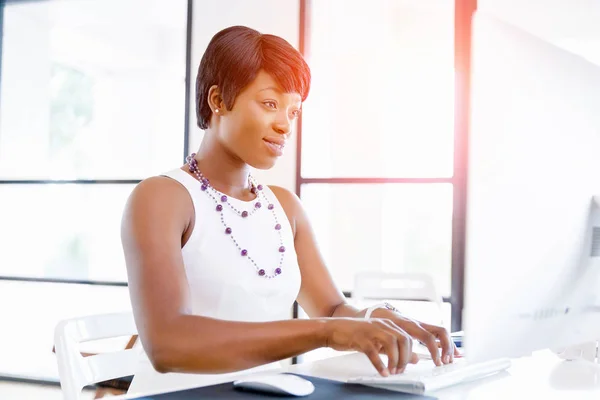 Portrait of businesswoman working at her desk in office — Stock Photo, Image